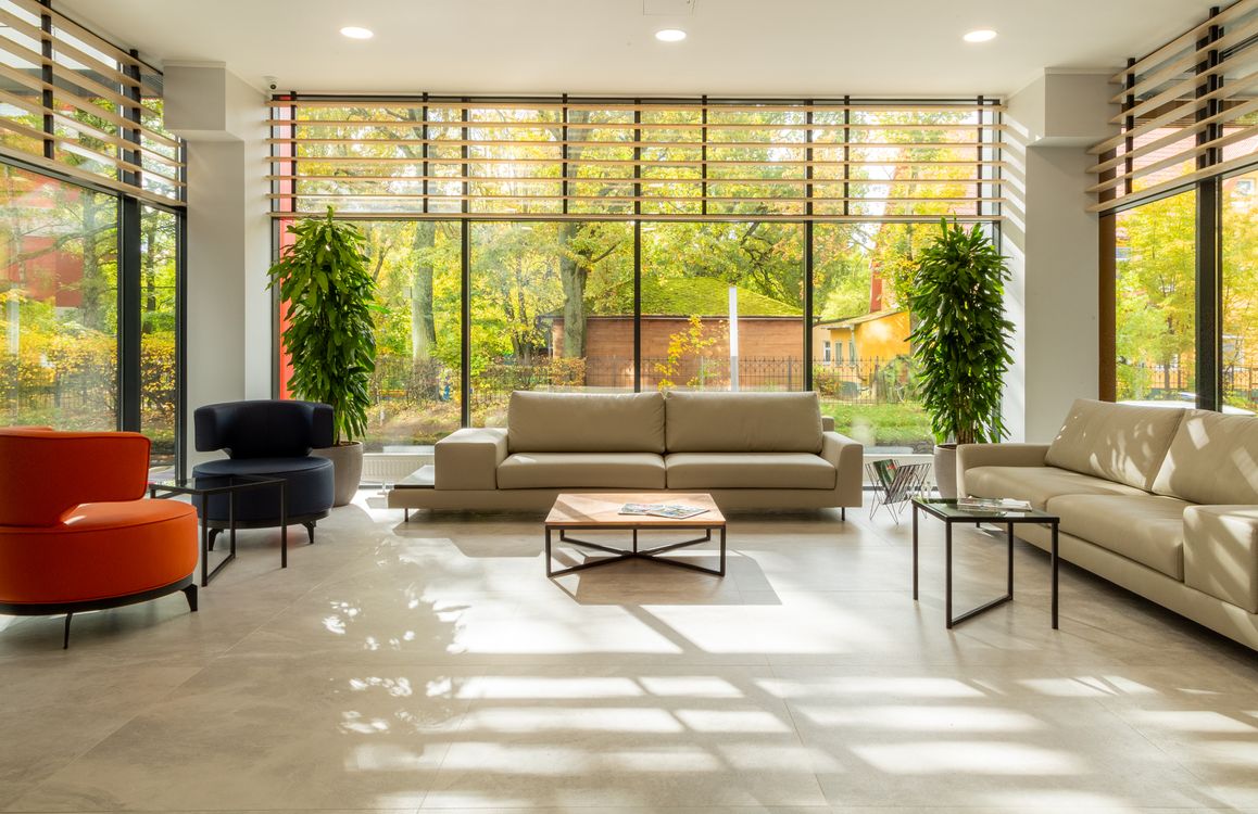Bright modern living room with large windows and comfortable seating